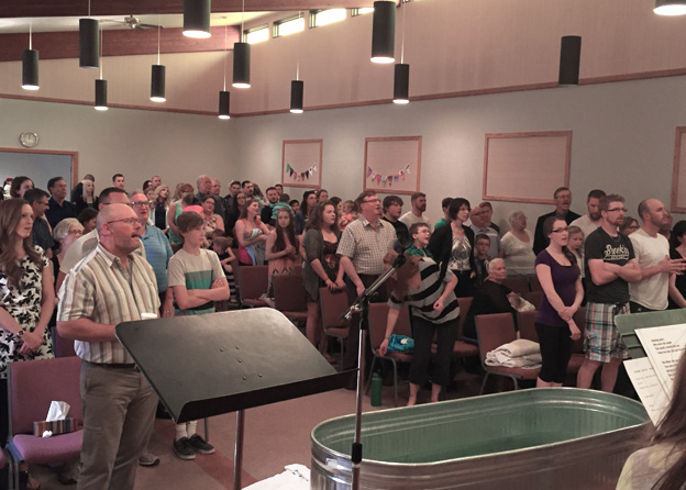 Congregation standing during baptism ceremony