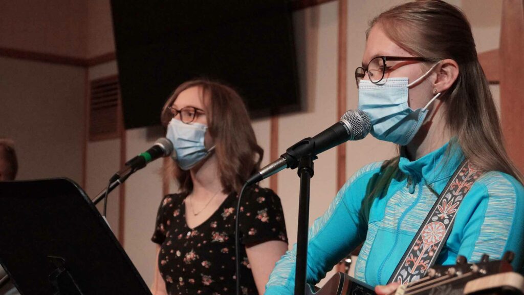 Girls singing and playing guitar for church