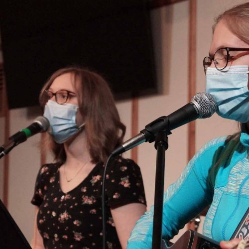 Girls singing and playing guitar for church